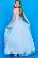 Young model in Jovani K66712 blue gown back view reflecting delicate beauty.