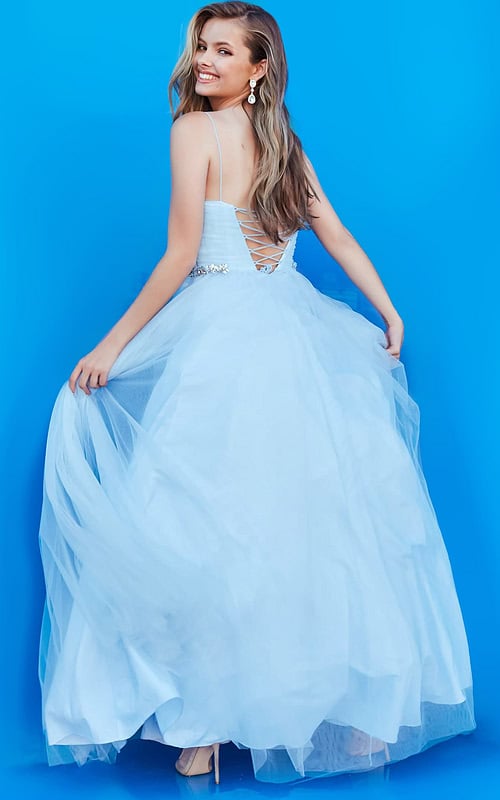 Back view of model in Jovani k66712 blue dress with lace-up detail and flowing tulle.