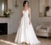 Woman in ivory satin strapless A-line gown with luxury wedding guest accessories