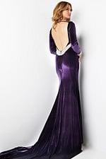 Model showcasing the open back detail of Jovani 09139 velvet purple gown.