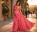 Pregnant woman wearing pink empire waist evening gown