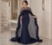 navy evening gown with sheer cape and floral appliqué in luxury interior