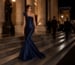 Navy satin mermaid cape gown at gala entrance