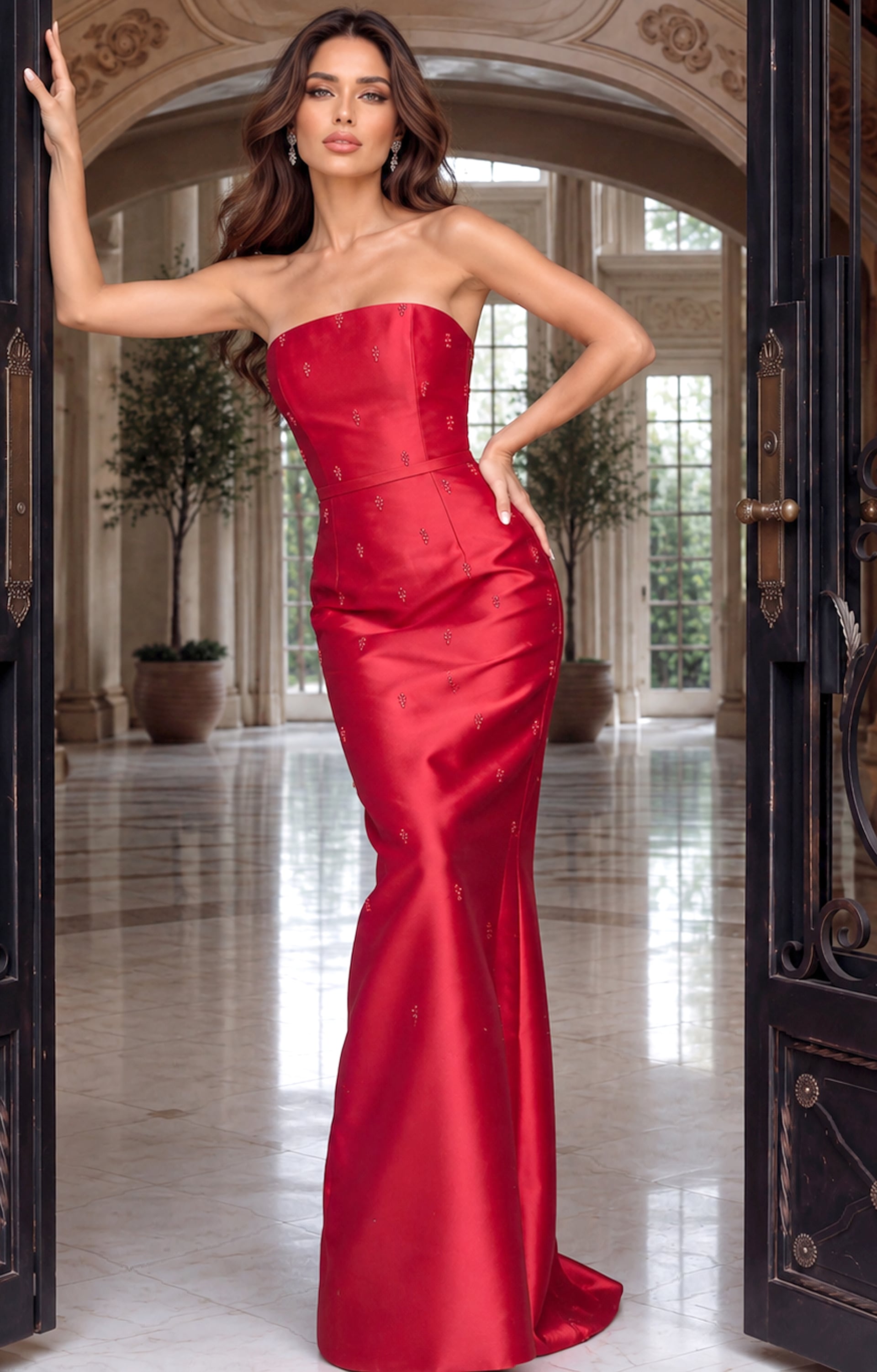 Model leaning in a crimson mikado gown with beaded specks and a flared floor-sweeping skirt