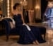 Pageant contestant preparing opera gloves with navy evening gown
