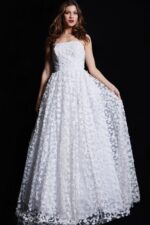 Model wearing Jovani 08536 ivory gown holding the skirt, showcasing floral lace details.
