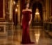 Red off-shoulder velvet evening gown in a luxury ballroom