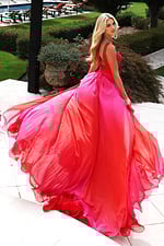 Model wearing two-tone chiffon gown with ruched bodice and flowing skirt