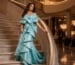 Turquoise sculptural mermaid gown on opera staircase