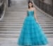 turquoise layered ball gown prom dress on staircase